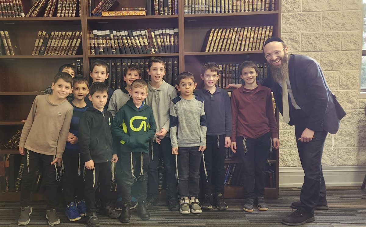 Rabbi Scheller smiling with boys after a Toronto One Time Torah class